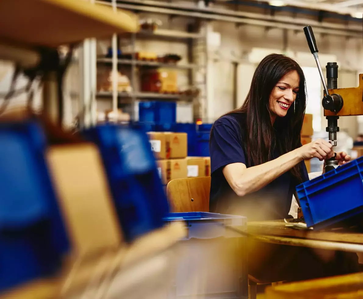 Smiling female working on a production site.
